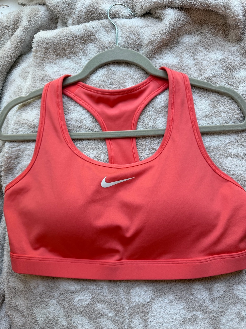 Nike Coral Pink Dri-FIT Sports Bra with White Swoosh Logo on the Front